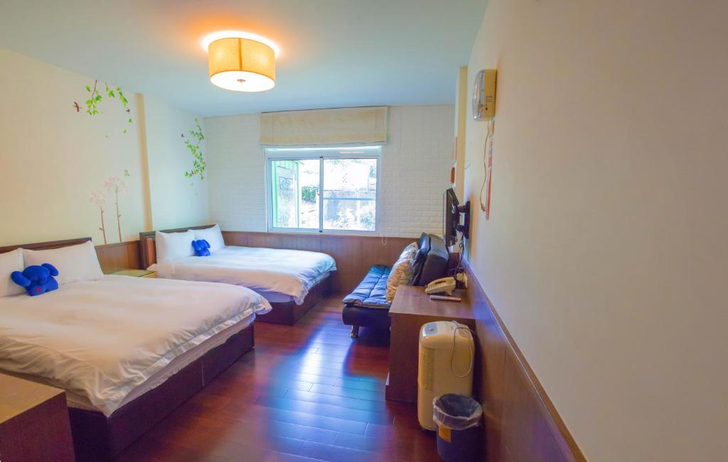 Postel nebo postele na pokoji v ubytování Siangting B&B