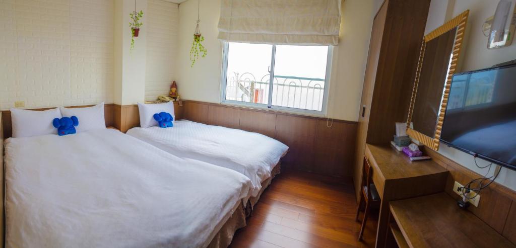 Postel nebo postele na pokoji v ubytování Siangting B&B