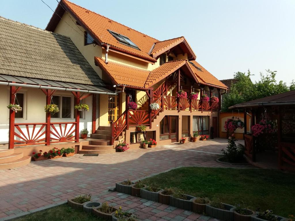 a building with red roofs and a courtyard at Casa Lenke in Săcele