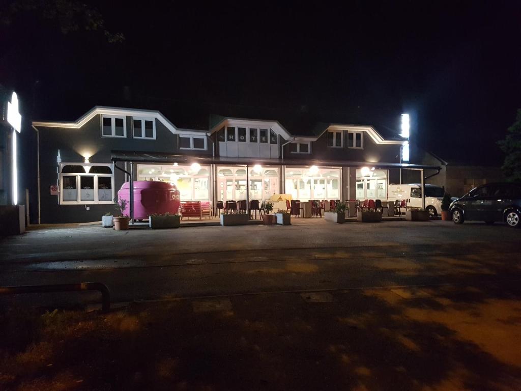 a store at night with lights in a parking lot at Apartments O Sole Mio in Vukovar