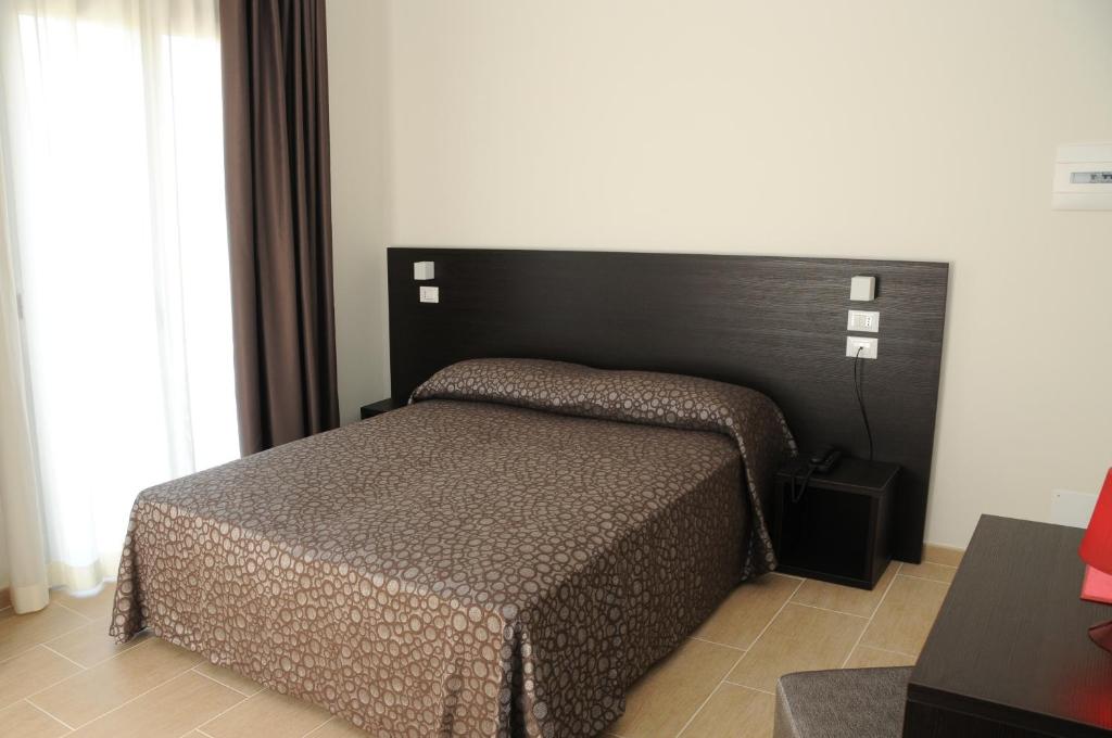 Łóżko lub łóżka w pokoju w obiekcie Hotel Morena