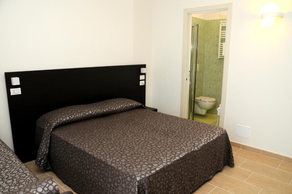 Łóżko lub łóżka w pokoju w obiekcie Hotel Morena