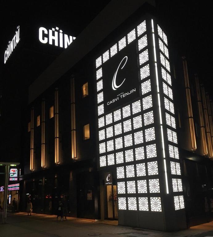 a building with a lit up sign on the side of it at Hotel CASVI Tenjin in Fukuoka