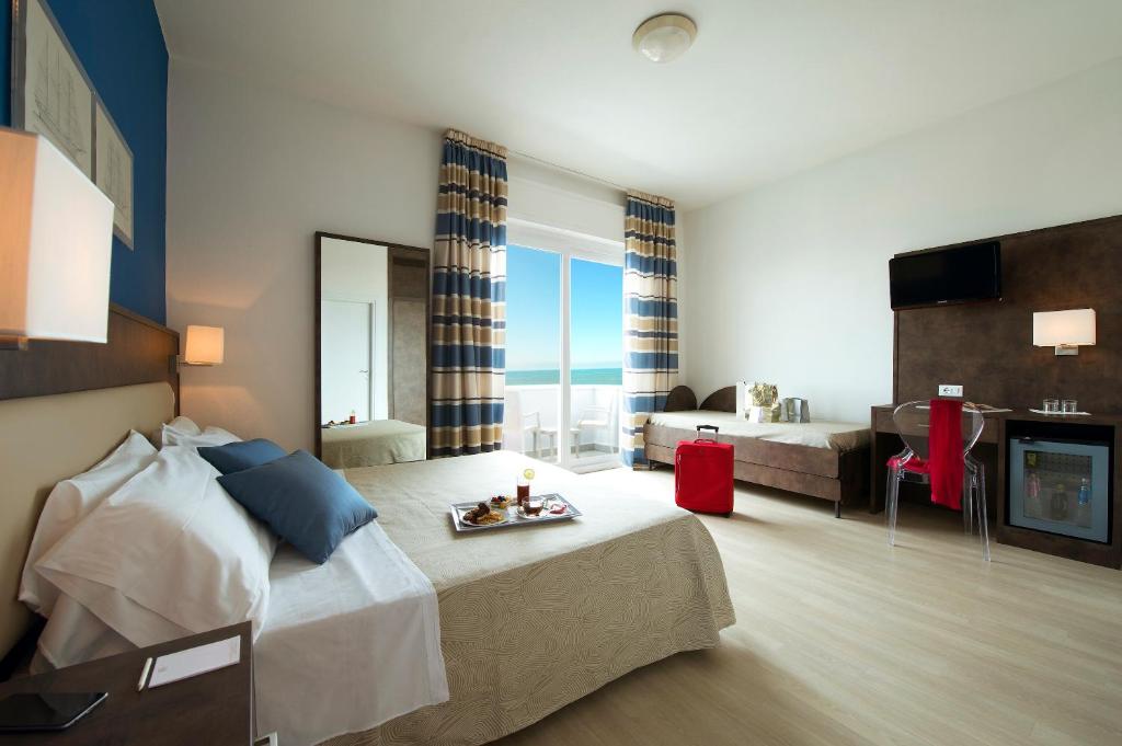 Postel nebo postele na pokoji v ubytování Hotel Giulia