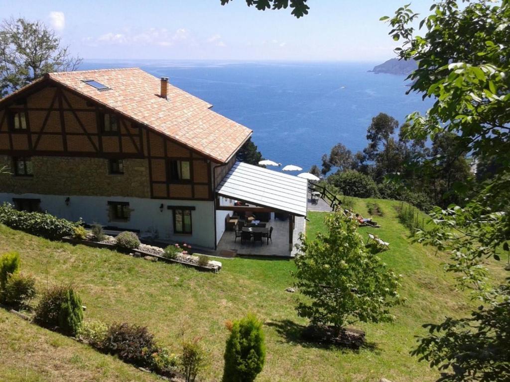 een huis op een heuvel met uitzicht op de oceaan bij Casa Rural Ogoño Mendi in Elantxobe