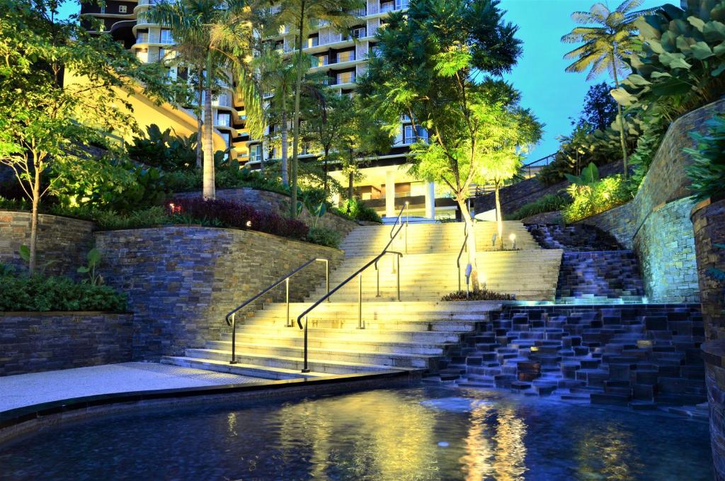 a pool of water with stairs in front of a building at Holi Afiniti Themed Suites in Nusajaya