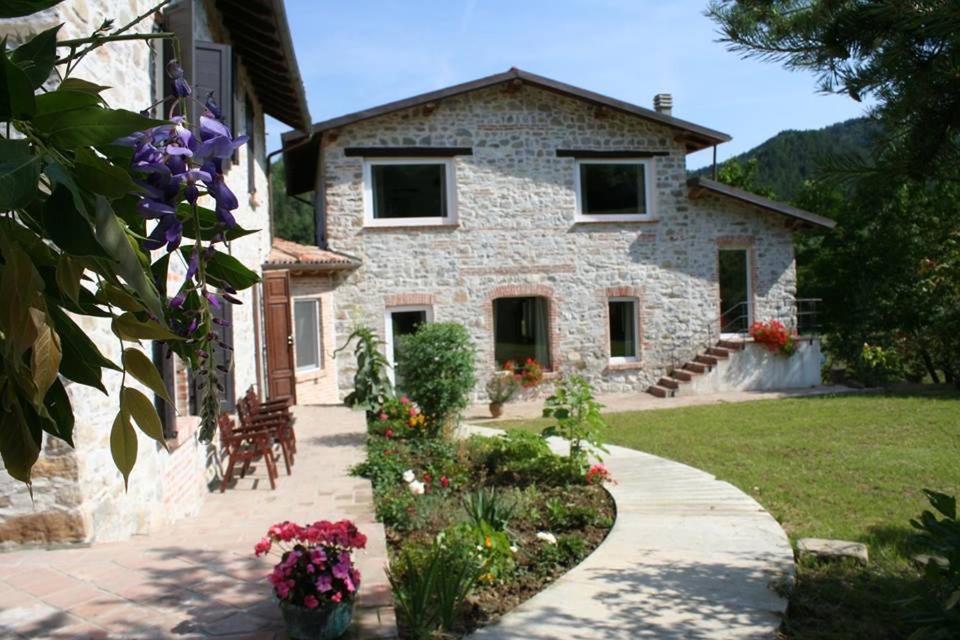 a stone house with a pathway in front of it at Agriturismo Malvista in San Sebastiano Curone