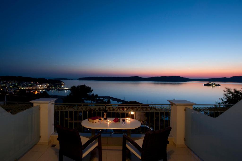 a view of the water from a balcony at night at Hotel Anezina in Pylos