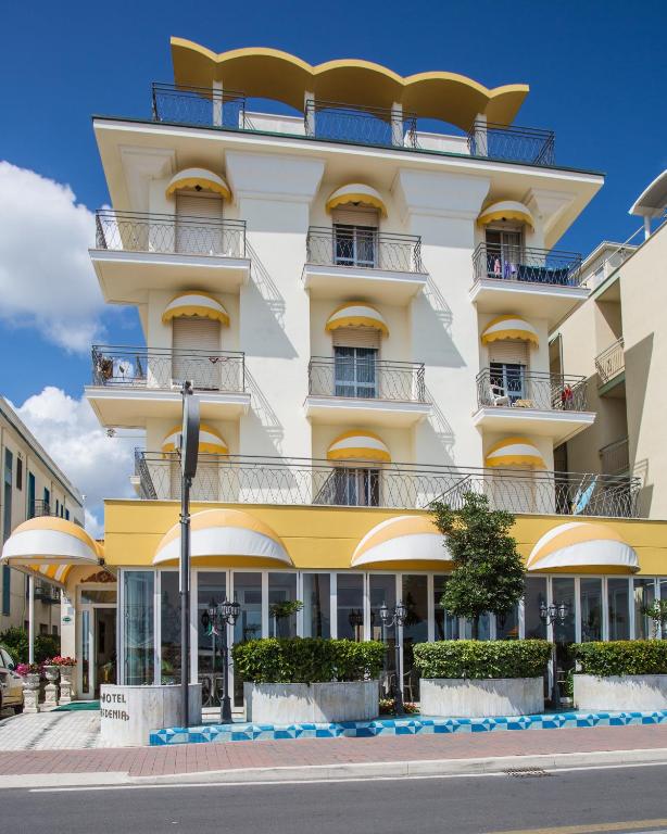 a building with balconies on a city street at Hotel Gardenia in Bellaria-Igea Marina
