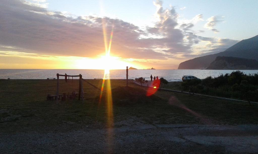 a sunset over the ocean with the sun shining at Buljarica Bay Apartments in Petrovac na Moru