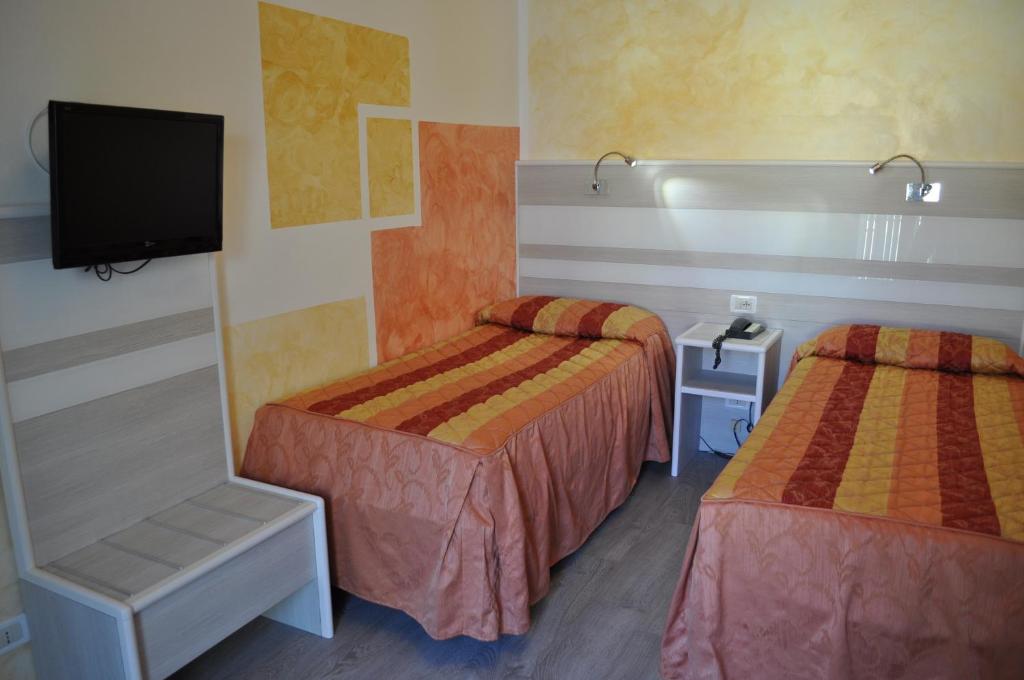Postel nebo postele na pokoji v ubytování Hotel Righetto Fronte Mare