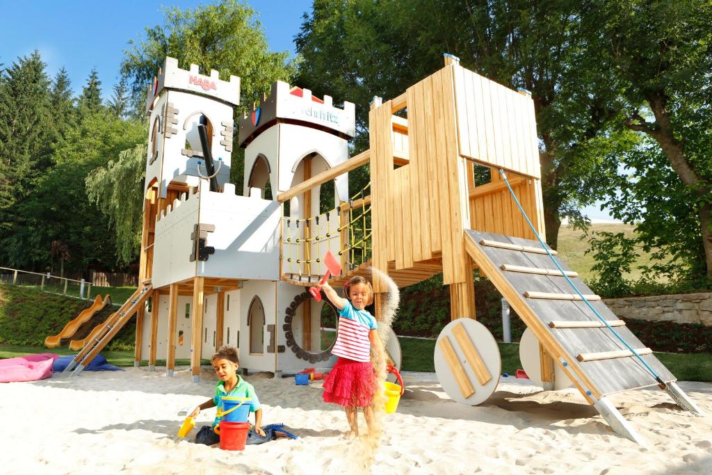 two children playing in the sand in a playground at Familienhotel Trebesingerhof in Trebesing