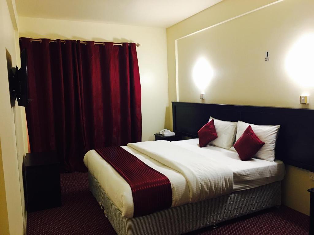 Postel nebo postele na pokoji v ubytování Simba Hotel