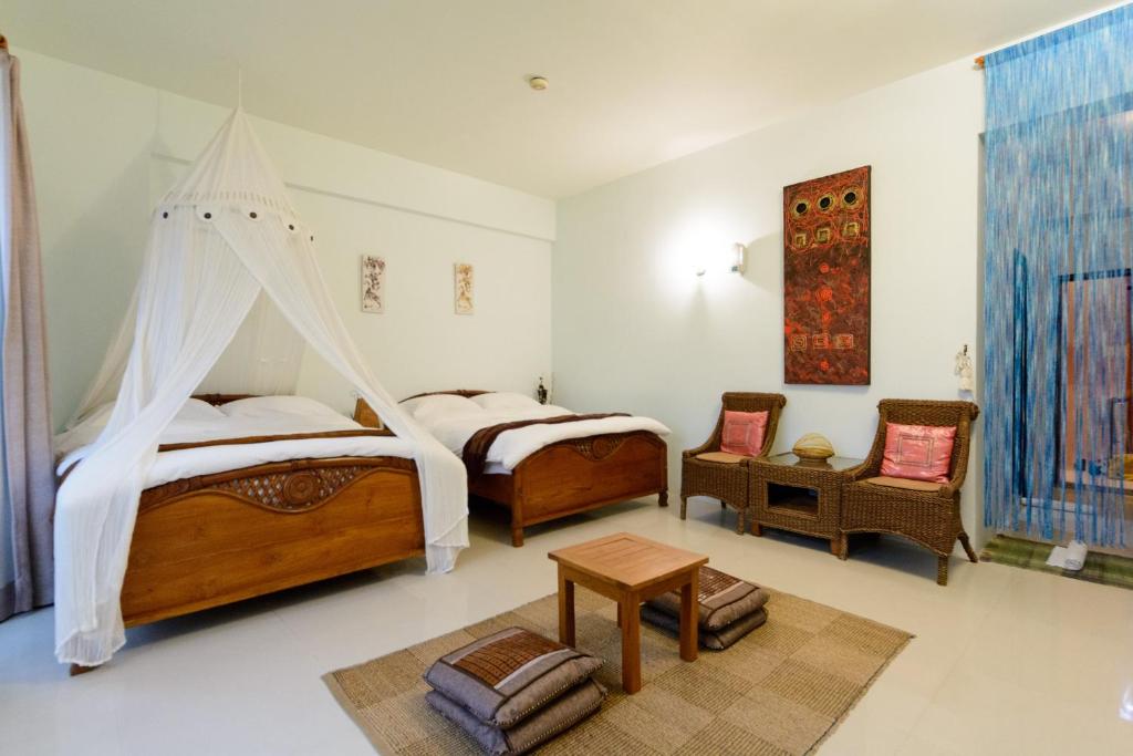 Bali House - Quadruple Room With Balcony