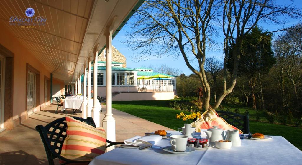 a table on the porch of a house at The Dixcart Hotel in Sark