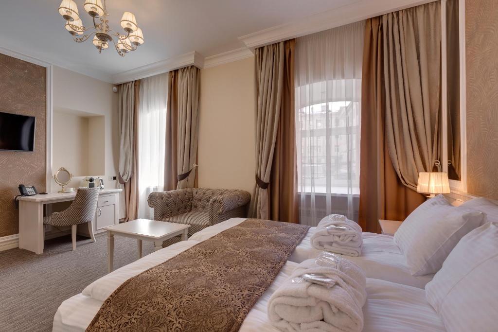 a hotel room with a large bed with towels on it at Anastasia Mini-Hotel in Saint Petersburg