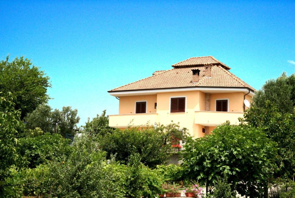 a large white house with trees in front of it at B&B Le Ginestre in Foria