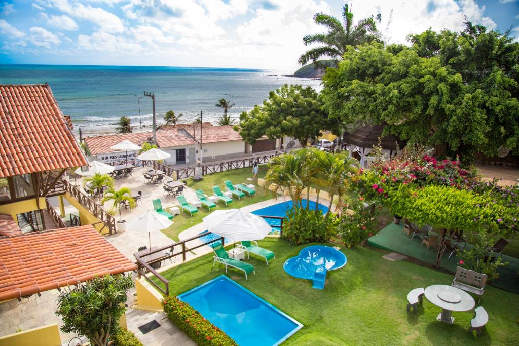 an aerial view of a resort with a pool and the ocean at Moriah Natal Beach Hotel in Natal