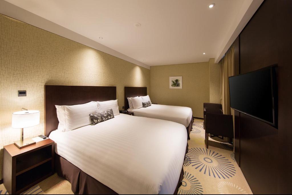 Postel nebo postele na pokoji v ubytování Solaria Nishitetsu Hotel Busan