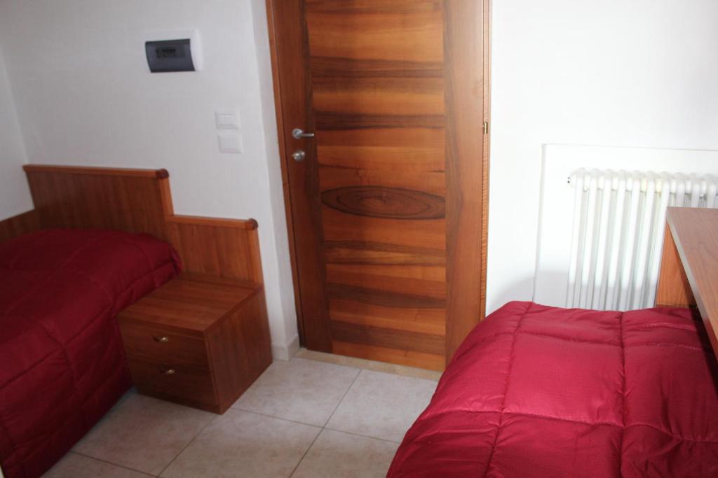 a bedroom with a bed and a wooden door at Residence Hotel Torresilvana in Vieste