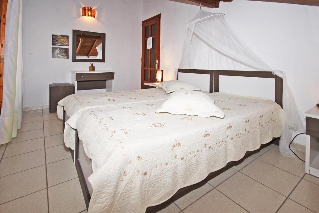 a bedroom with a large white bed in a room at Villa Angela in Vourvourou