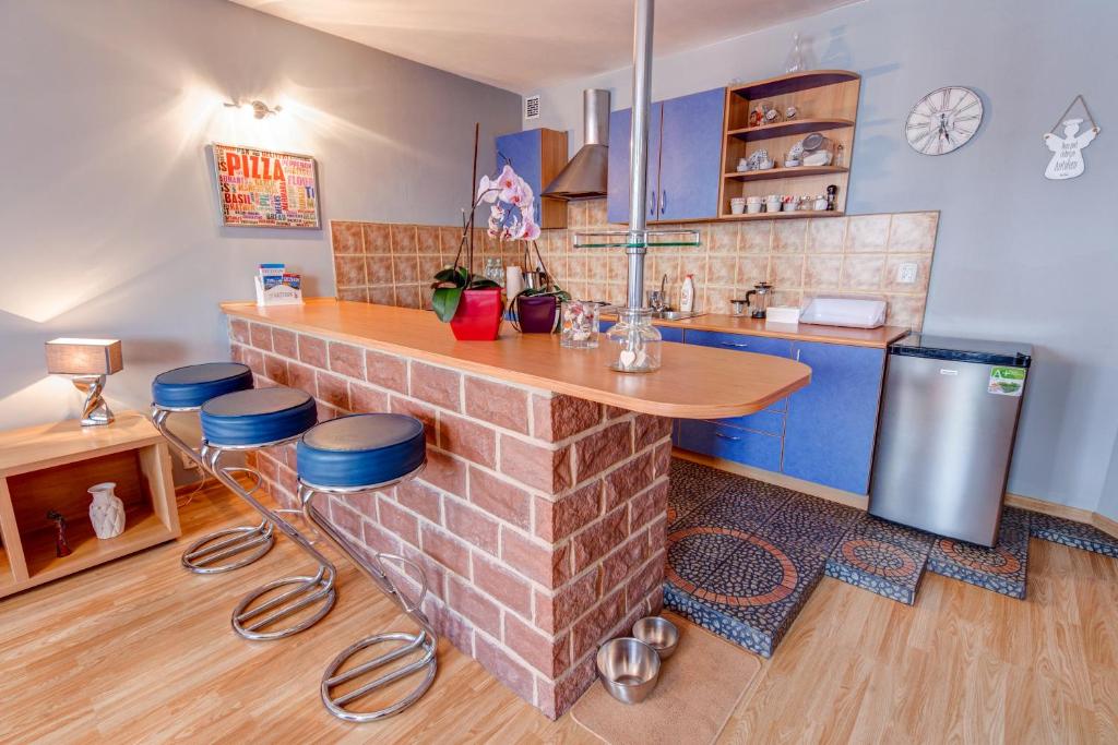 a kitchen with a brick counter and blue cabinets at Apartament MonteCassino in Szczecin