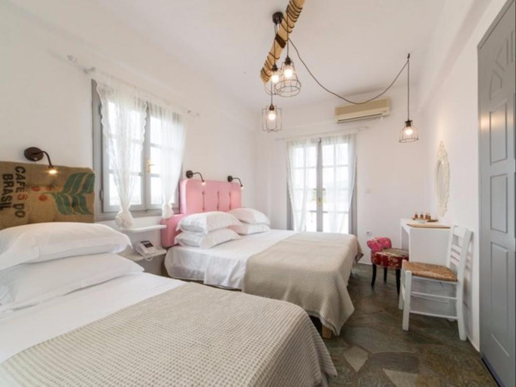 Postel nebo postele na pokoji v ubytování Evi Rooms