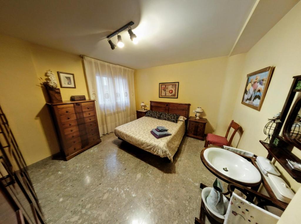 a bedroom with a bed and a sink in it at Casa Rosa in Alcañiz
