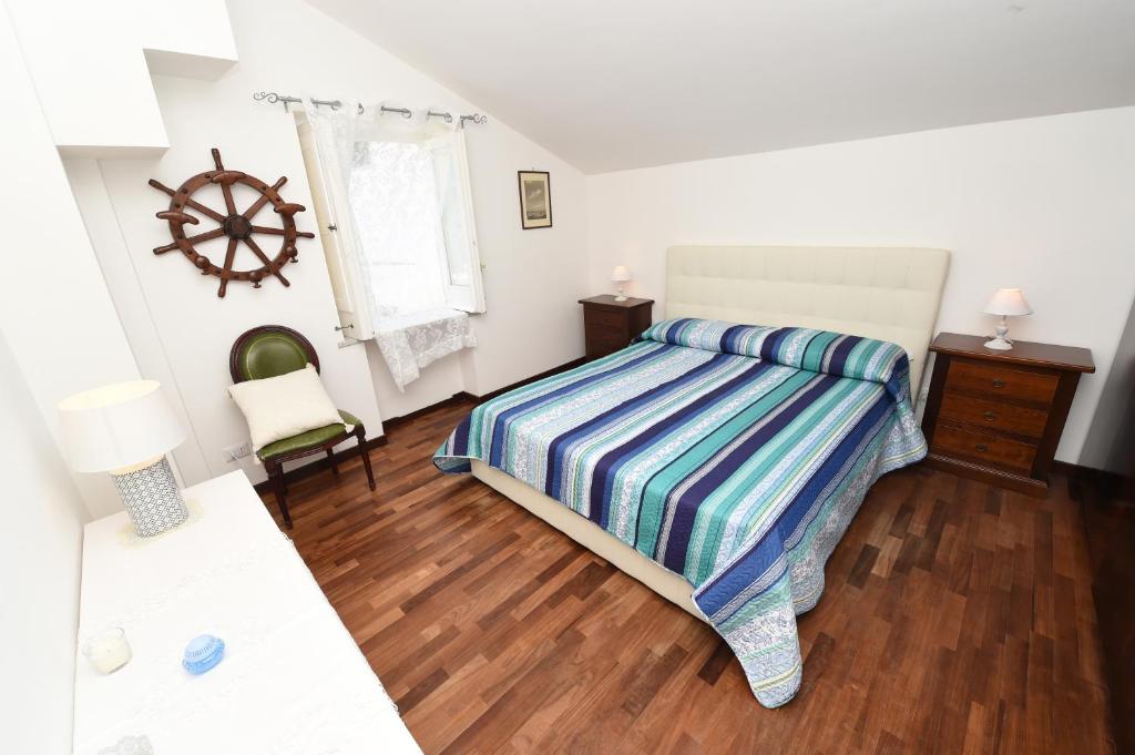 a bedroom with a bed and a wooden floor at Maison Fabrizia in Sorrento