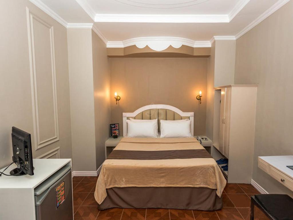 Postel nebo postele na pokoji v ubytování Urban Travellers Hotel