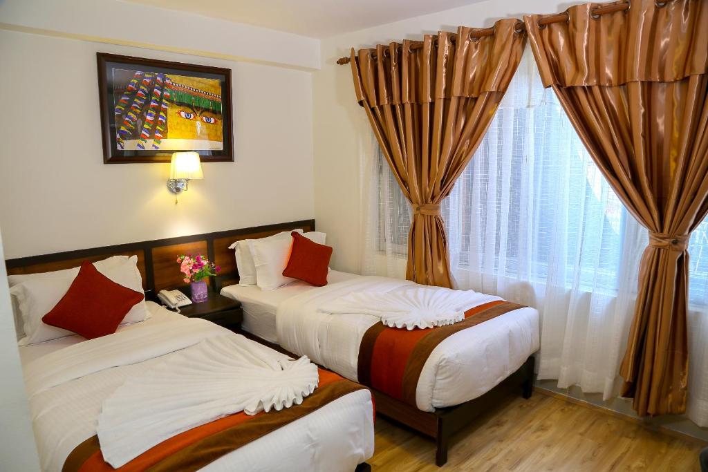 Postel nebo postele na pokoji v ubytování Hotel Himalayan Oasis
