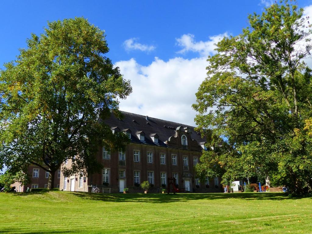 a large building with trees in front of it at Kloster Langwaden in Grevenbroich