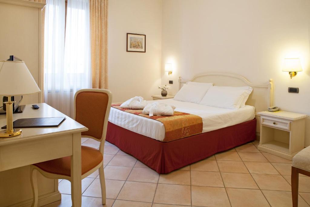 Postel nebo postele na pokoji v ubytování Hotel Le Mura