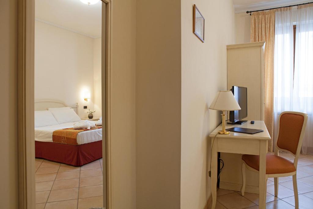 Postel nebo postele na pokoji v ubytování Hotel Le Mura
