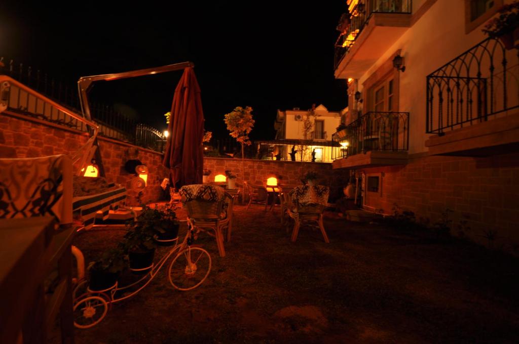 a bike parked next to a building at night at Cunda Svila Otel - Adult Only in Ayvalık