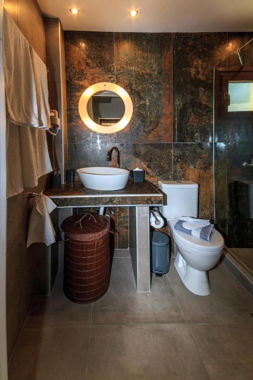 a bathroom with a sink and a toilet at Kissos Apartments in Vourvourou