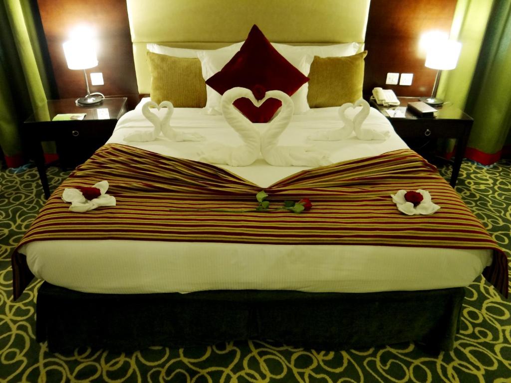 a hotel room with a bed with a heart made out of towels at Concorde Hotel Fujairah in Fujairah
