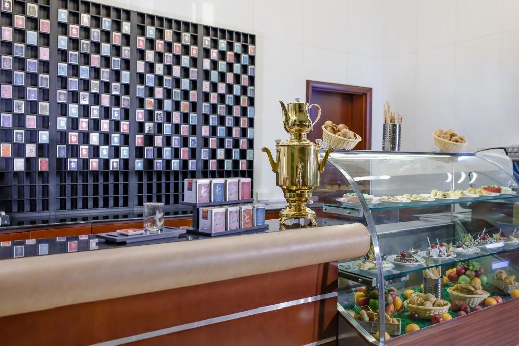 a buffet with a trophy and desserts on display at Concorde Hotel Fujairah in Fujairah