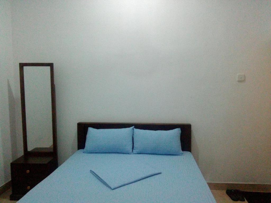 Postel nebo postele na pokoji v ubytování Diyawara Home Stay