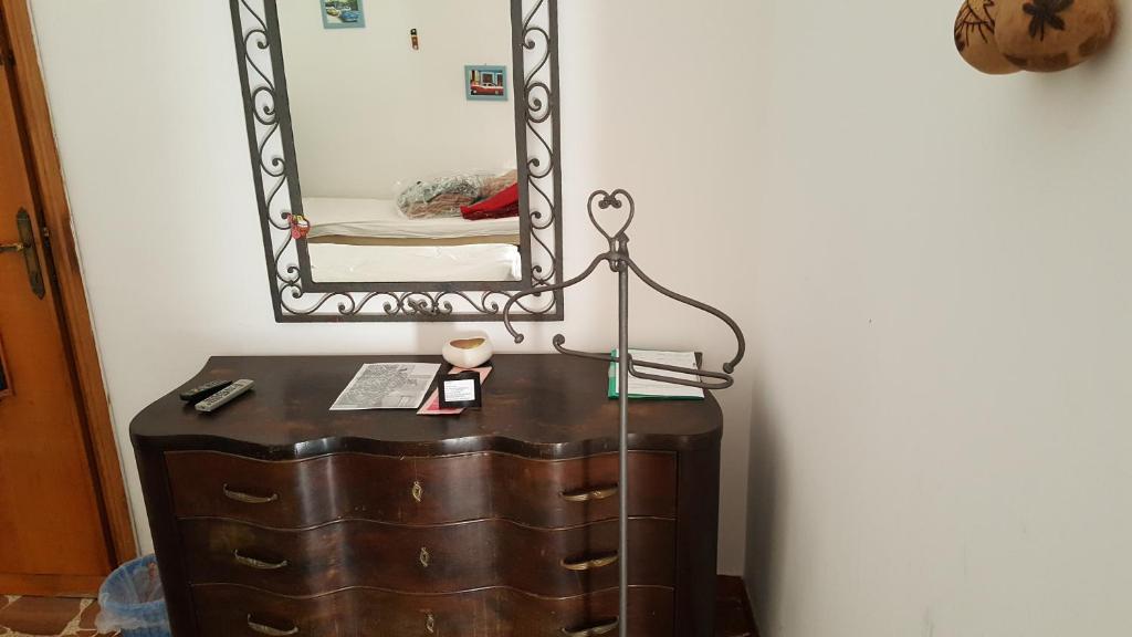 a dresser with a mirror on top of it at Calciufetta in Alghero