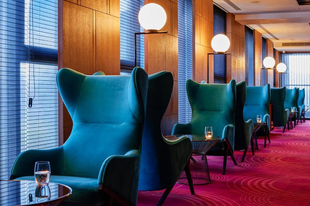 a row of chairs in a restaurant with wine glasses at H2O HOTEL in Kaohsiung