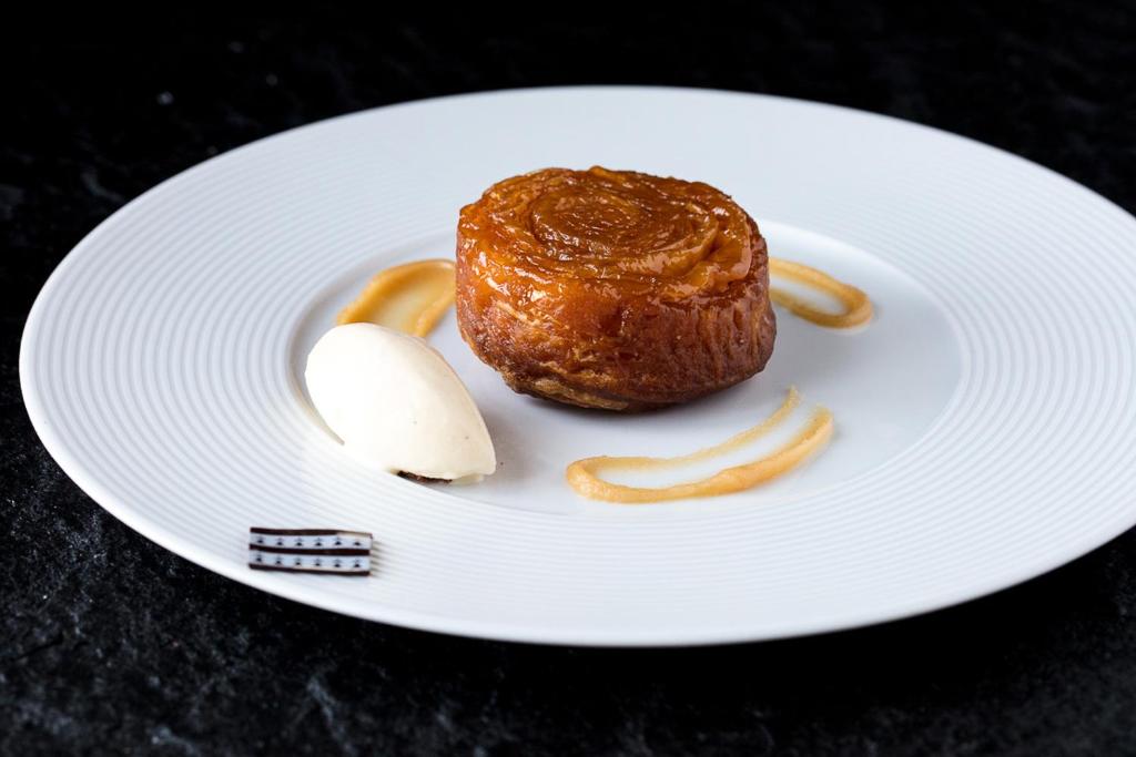 a white plate with a piece of food on it at Castel Beau Site in Perros-Guirec