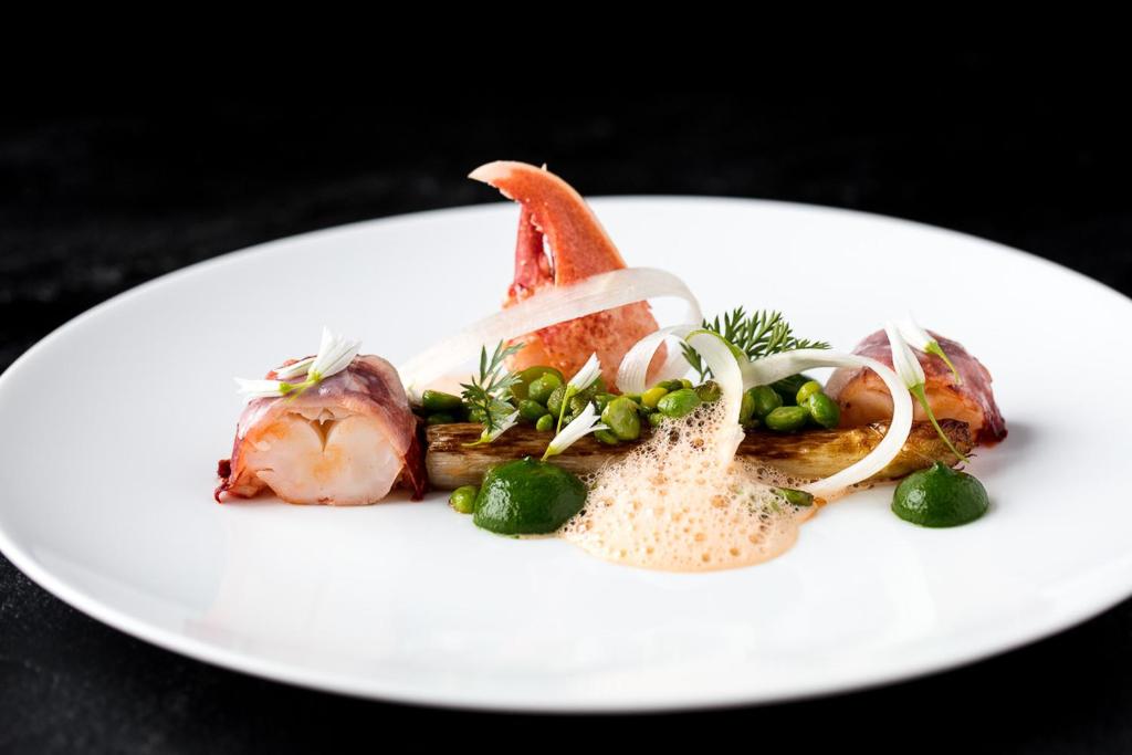 a white plate of food with seafood on it at Castel Beau Site in Perros-Guirec