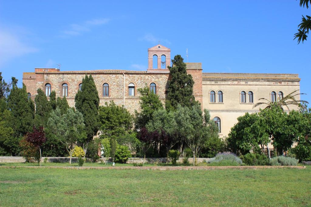 a large brick building with a tower on top of it at Alberg Solidança Hostel in Palafrugell