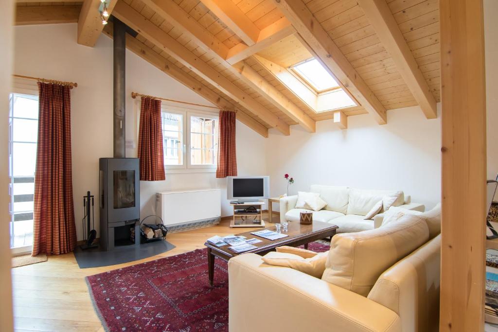 a living room with a couch and a table at Chalet Renu in Saas-Fee