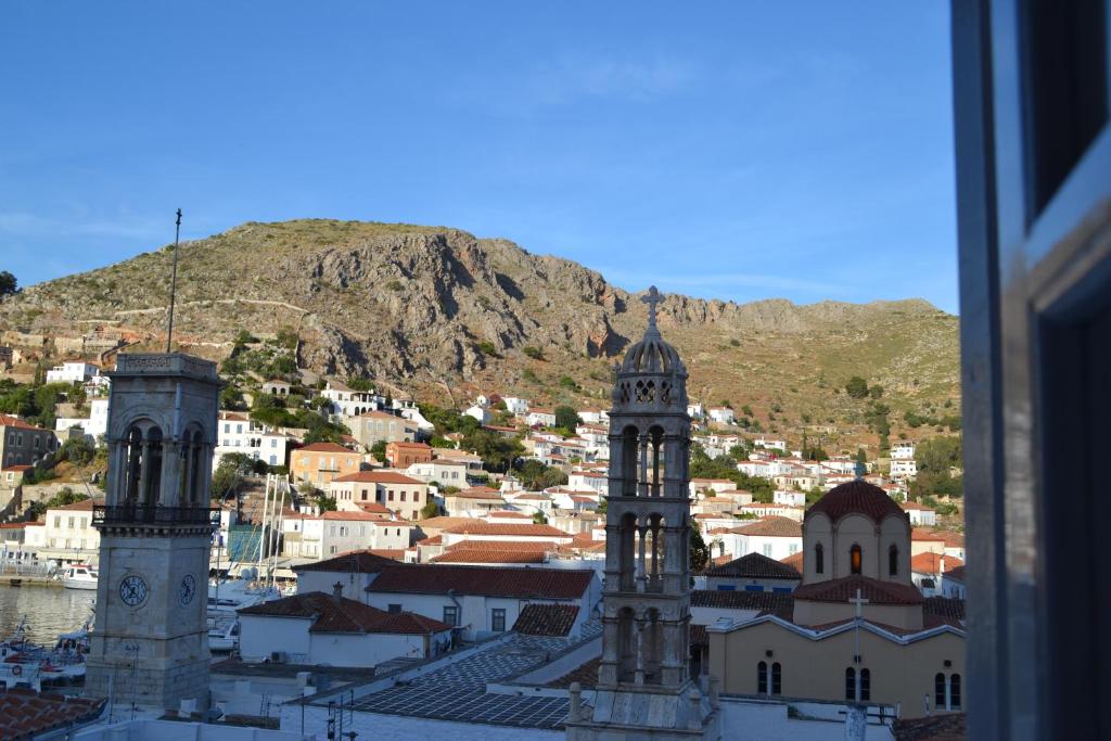 a large building with a clock tower on top of it at Pension Efie in Hydra