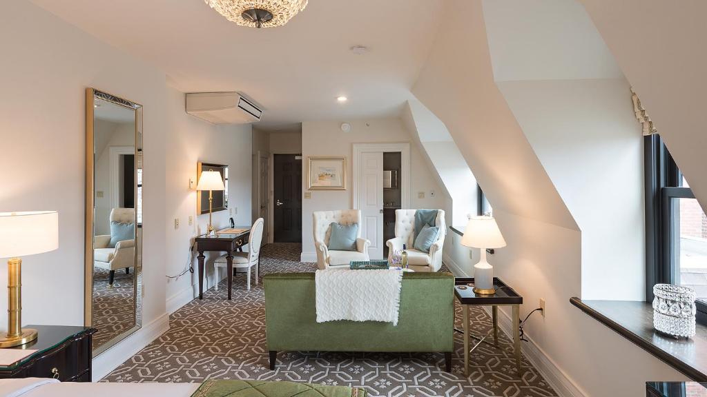 a living room with a couch and a table at Sydney Boutique Inn & Suites in Charlottetown