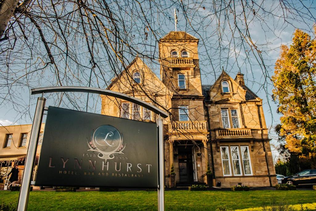 an old building with a sign in front of it at Lynnhurst Hotel in Johnstone