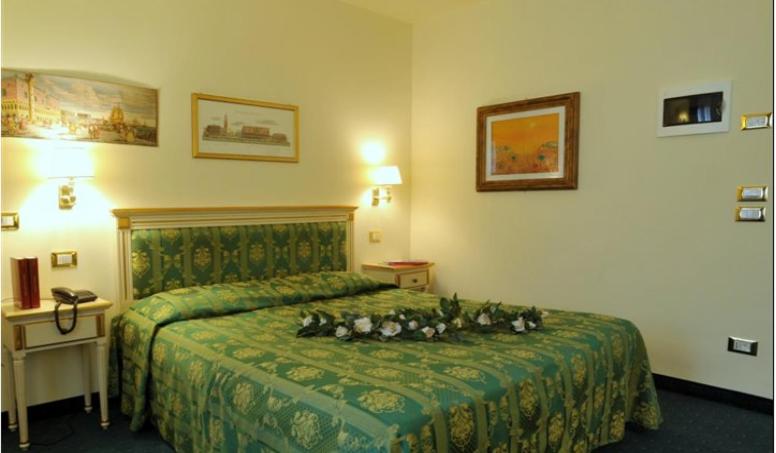 a group of dogs laying on a bed in a hotel room at Villa Crispi in Mestre