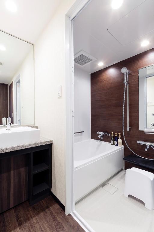a bathroom with a tub and a sink at Hotel Mystays Premier Akasaka in Tokyo